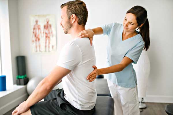 Woman chiropractor working on a male patient